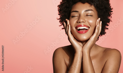 Beauty face of African woman touch clean and fresh hydrated skin, perfect facial nude makeup and smile. Girl advertising cosmetics with spf sun protecting, botanical ingredients