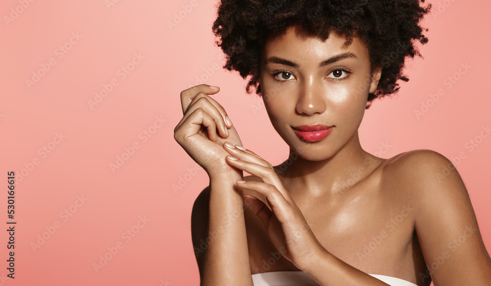 Young woman applying soft skin care cream on her body after shower