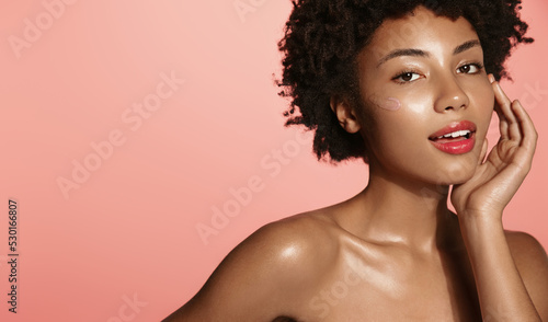 Obraz na płótnie Young african american girl with clear skin, washing her face and body, looking