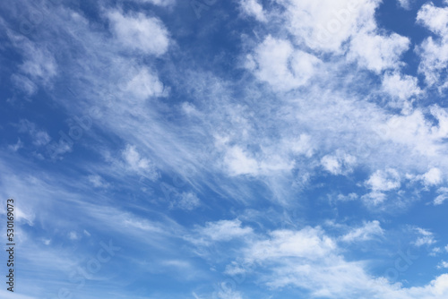 Soft and fluffy clouds formation on the bright sunny blue sky. Nature abstract background. Fresh air, weather and freedom concept