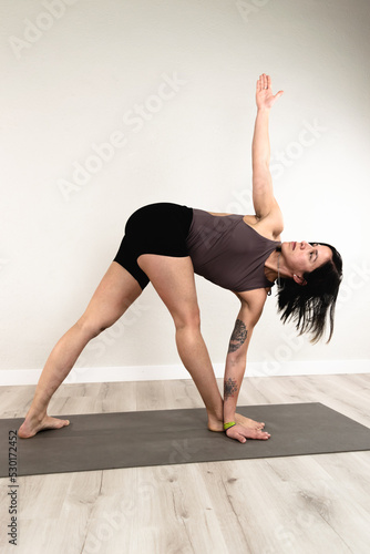 Young woman practices yoga at home. Healthy body and mind concept.