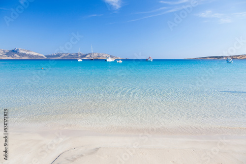 Dreamy sandy beach of crystal clear turquoise waters in Koufonisi island, Cyclades islands, Greece, Europe.  photo