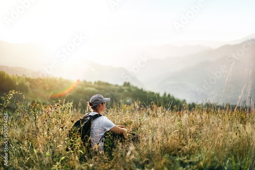 Hiker resting on mountain at sunset © adrianad