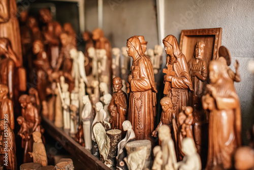 Various handmade religious souvenirs from carved wood on display at African market