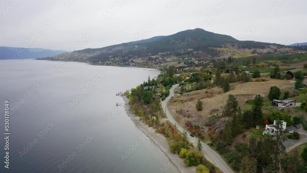 Aerial view of truck driving down lakeside road, fall season Aerial view of truck driving down lakeside road, fall season