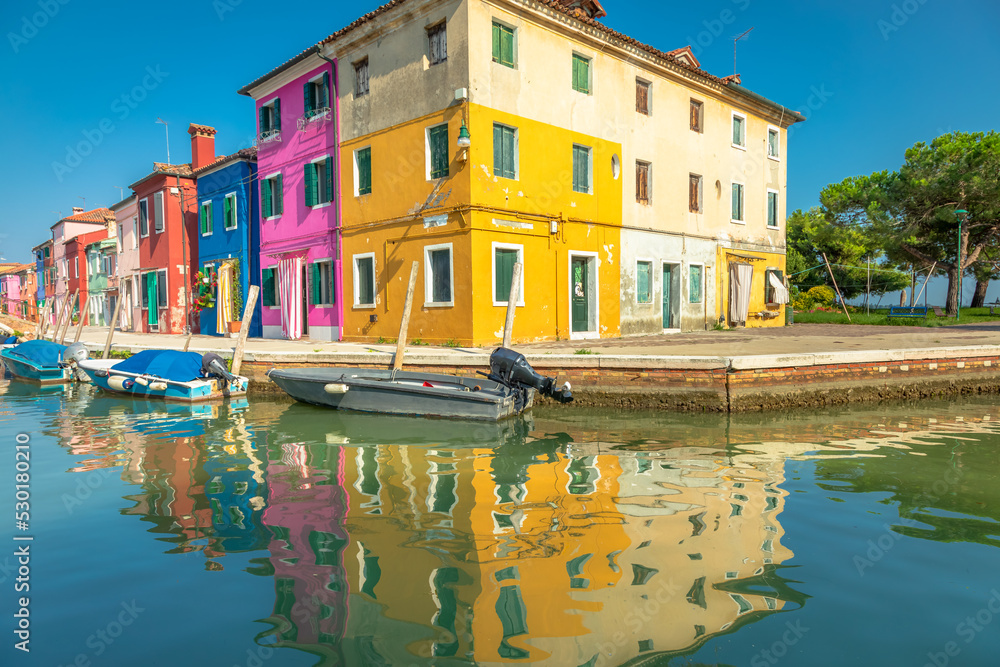 Burano island canal reflection, colorful houses and boats, Venetian lagoon