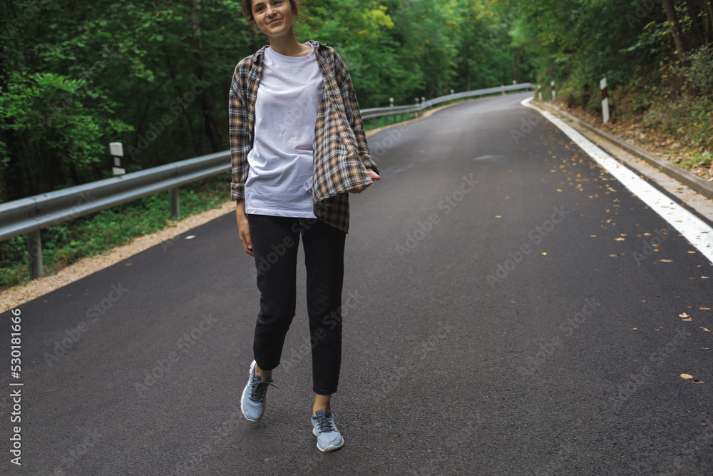 beautiful girl walks in the forest near the road beautiful girl walks in the forest near the road