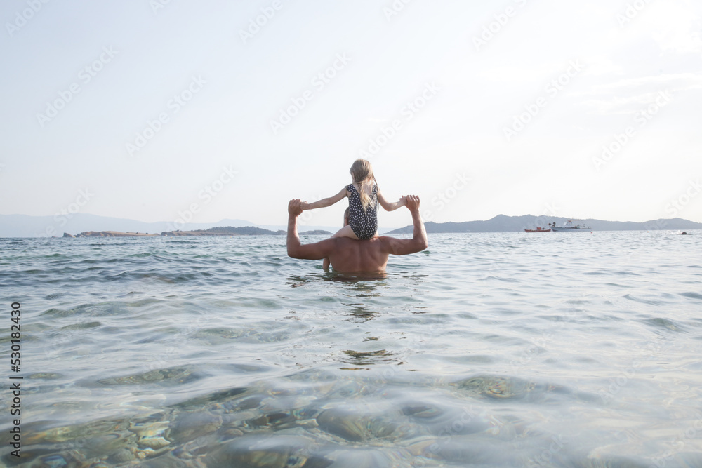Father and his little daughter in the sea water, fun family summer vacation Father and his little daughter in the sea water, fun family summer vacation