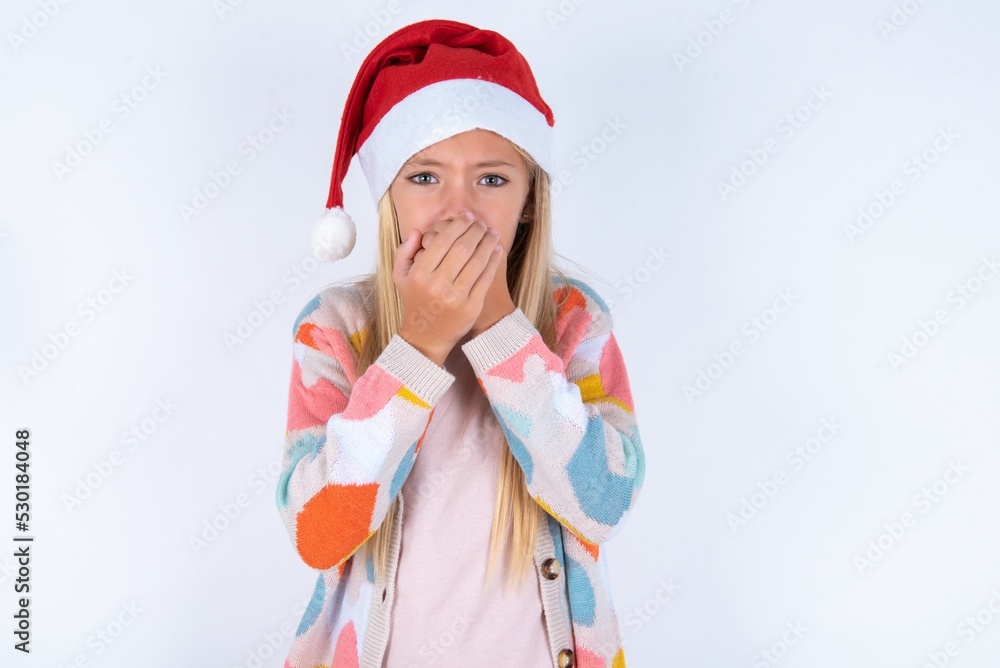 little kid girl with Christmas hat wearing yarn jacket over white background holding oneself, feels very cold outside, hopes that will not get cold little kid girl with Christmas hat wearing yarn jacket over white background holding oneself, feels very cold outside, hopes that will not get cold