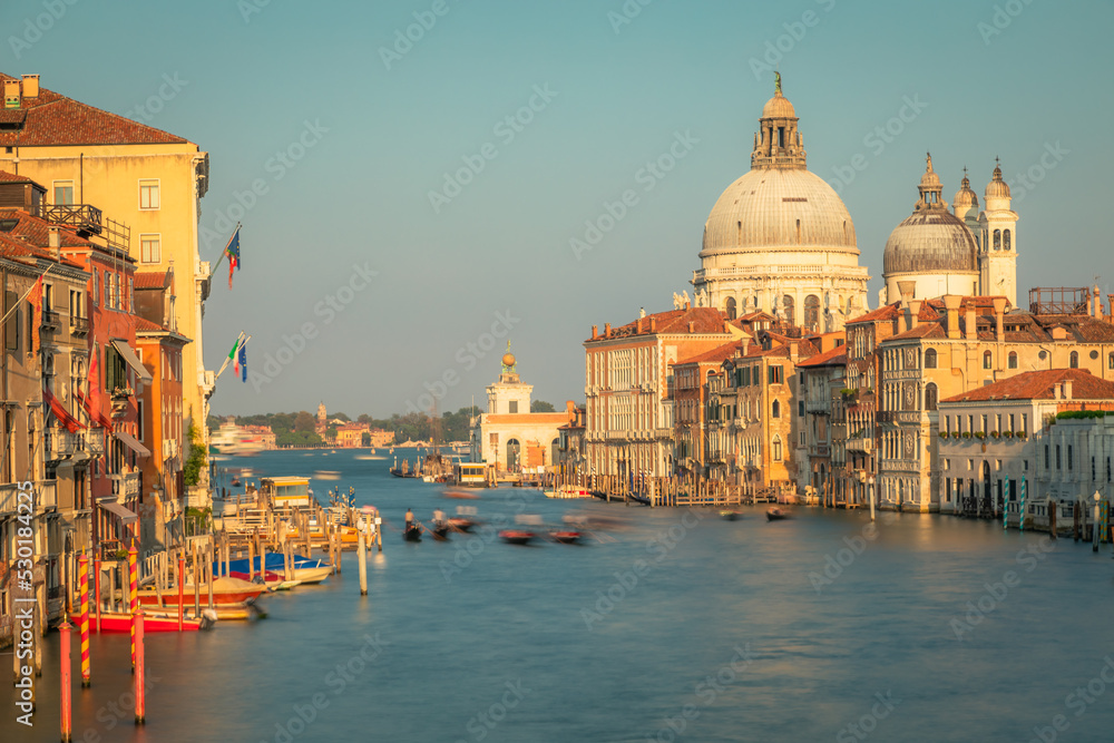 Blurred Gondole in grand canal at golden sunrise, Ethereal Venice, Italy