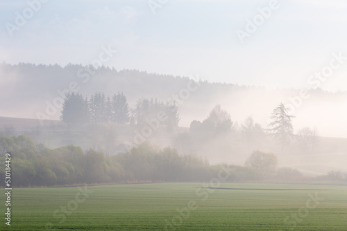Rural landscape at Ondrasova village shrouded in morning mist.