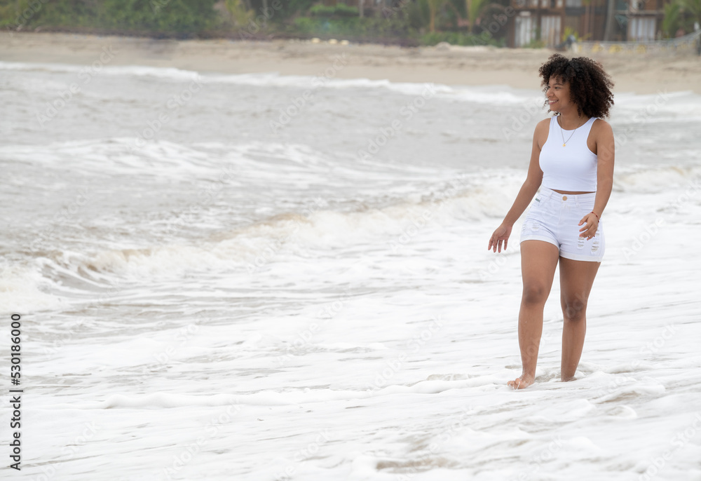 Afro american woman walking on the beach Afro american woman walking on the beach