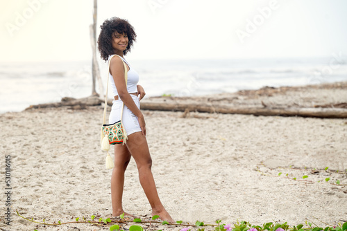 Carefree woman walking on the beach. 