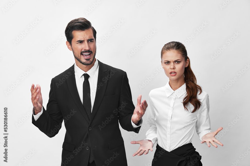 Man and woman anger business in business at each other shouting with their hands up in the air against a white isolated background. The concept of business in a couple harassment startup copy space Man and woman anger business in business at each other shouting with their hands up in the air against a white isolated background. The concept of business in a couple harassment startup copy space