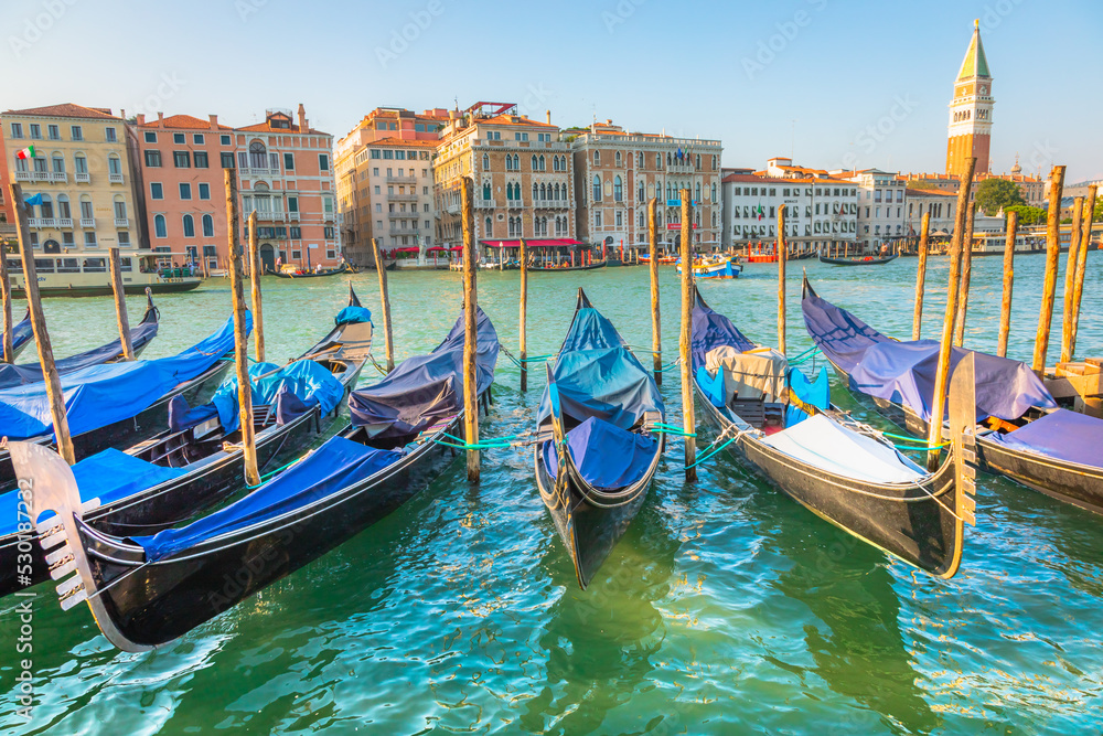Gondolas in Grand Canal and campanile at golden sunset, Venice, Italy
