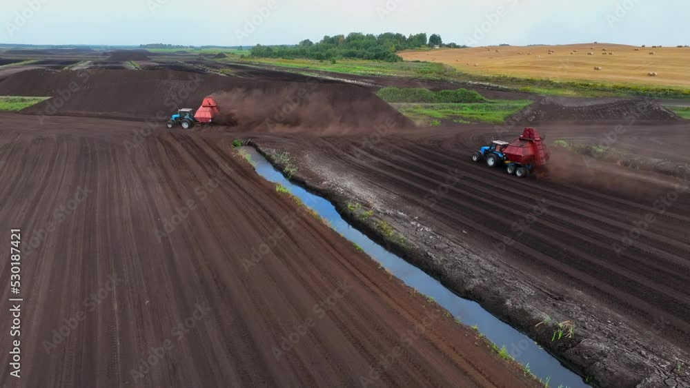 Peat Harvester Tractor on Collecting Extracting Peat. Mining and harvesting peatland. Area