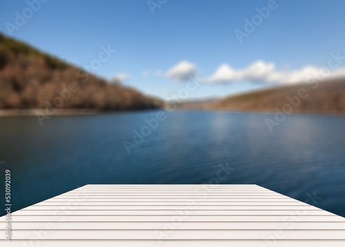 Old wood dock, lake and trees background