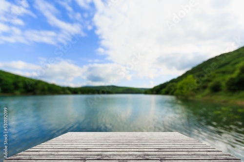 Old wood dock, lake and trees background © BillionPhotos.com