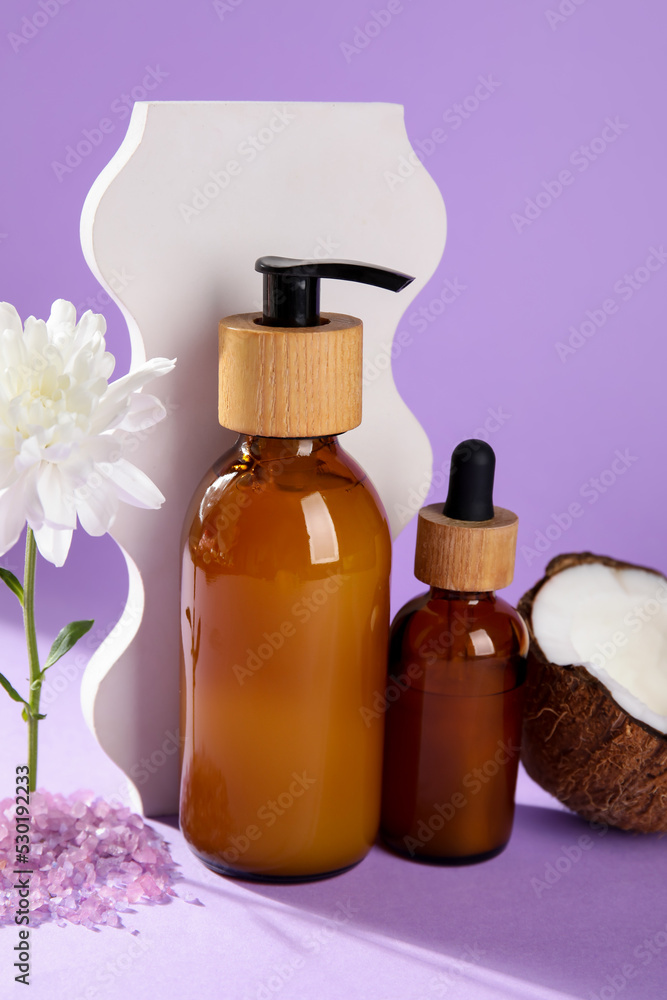Bottles of natural cosmetic products on lilac background Bottles of natural cosmetic products on lilac background