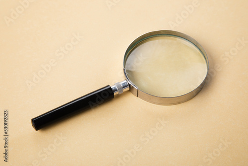 Magnifying glass on orange background