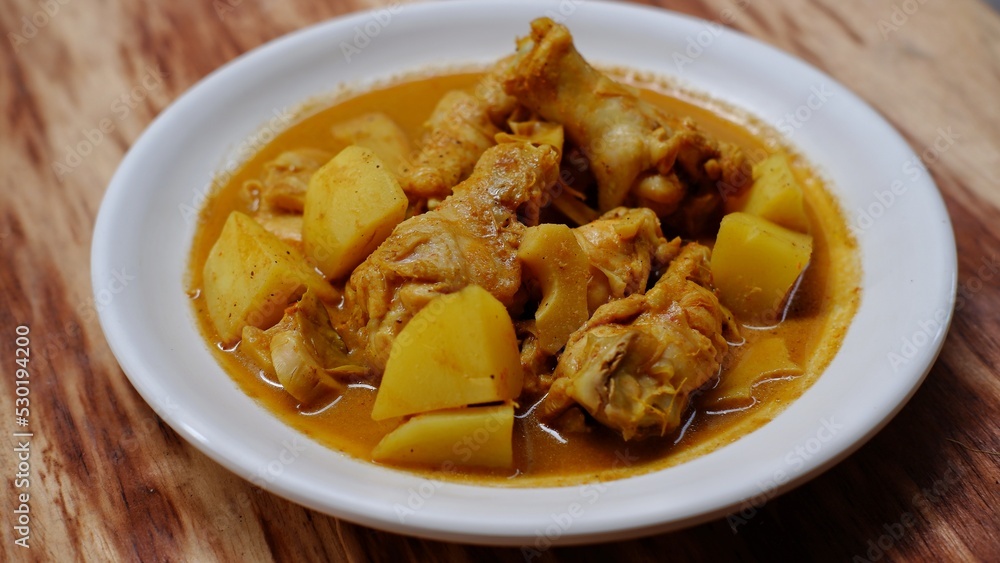 Gulai ayam dan kentang. Indonesian chicken curry with potato. Is traditional side dish from Minangkabau cuisine Gulai ayam dan kentang. Indonesian chicken curry with potato. Is traditional side dish from Minangkabau cuisine