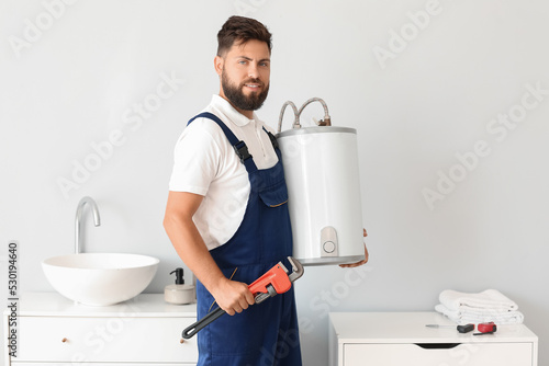 Male plumber with boiler an...