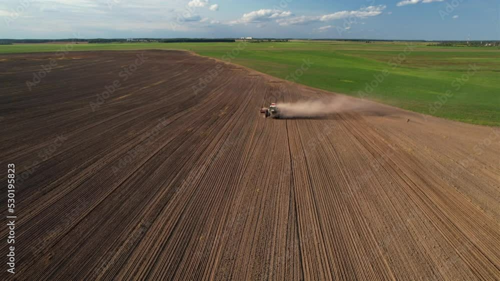 Disk harrow on plowing field. Soil cultivation field use tractor