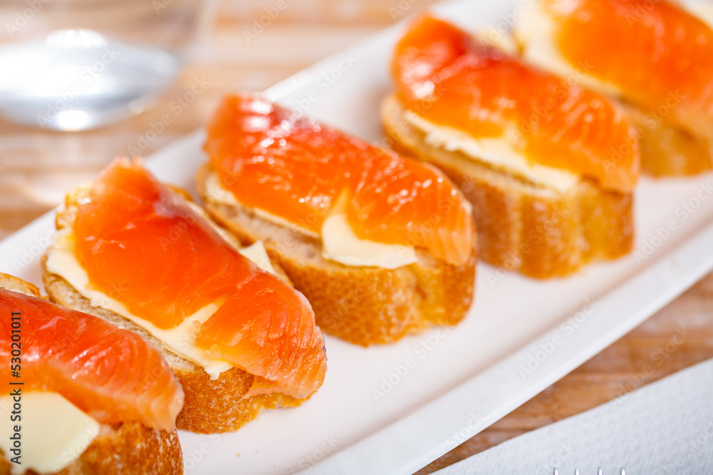 Salmon toasts with butter. Delicious lunch, healthy food, fish sandwich, diet snack