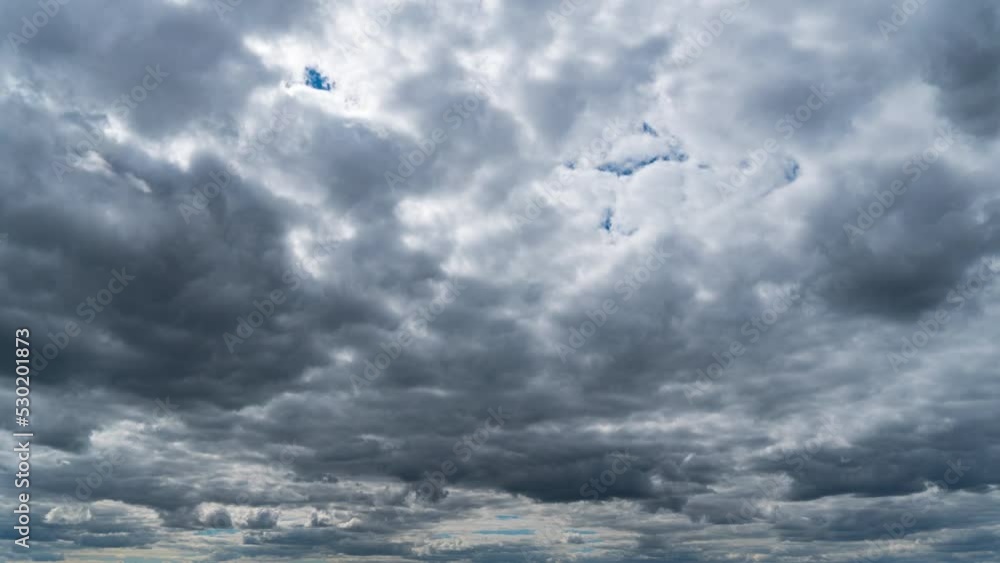 Timelapse gray rainy clouds float across the dark sky on a cloudy day. Cloudy sky and gloomy clouds. Magic dramatic sky in rainy weather. Ominous clouds slowly drift across the sky, threatening rain.