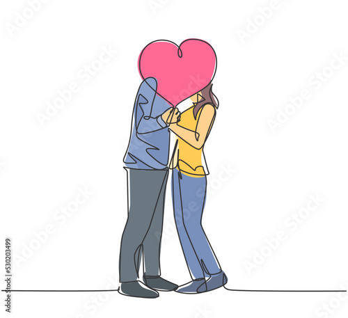 One single line drawing of young happy couple man and woman kissing and covered by heart shape balloon celebrating their marriage. Romantic love concept continuous line draw design vector illustration
