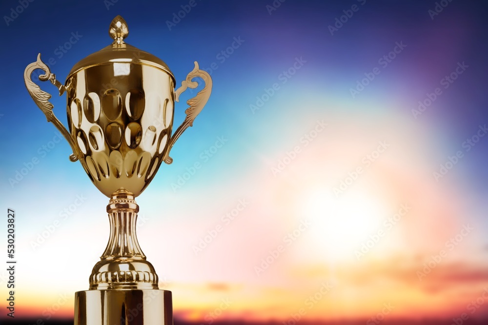 Obraz premium Golden winner trophy on dark sky background