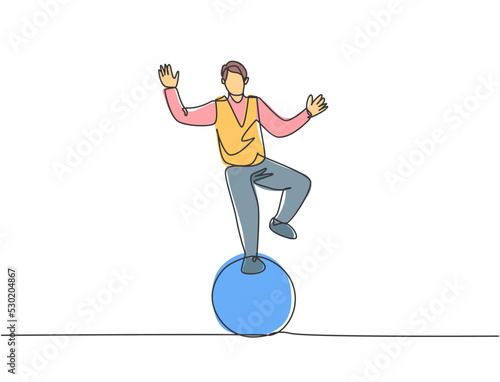 Continuous one line drawing a male acrobat performs a standing stunt with one foot on a circus ball while performing a dance. Interesting for the audience. Single line draw design vector illustration.