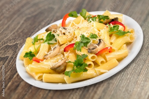 Italian pasta salad with cheese, tomato, mushroom and fresh vegetables.