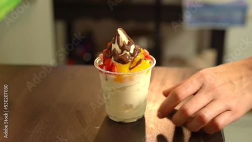 Hand lif take ice cream fruits natura chocolate in slow motion berries peach gold photo