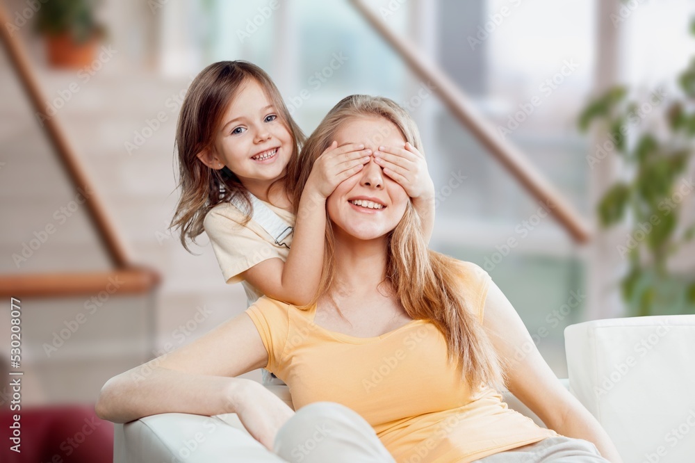 Beauty family. Happy mother and little girl smiling home room. Mothers day concept. Beauty family. Happy mother and little girl smiling home room. Mothers day concept.