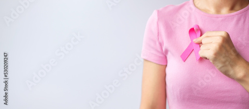 Fotografering Pink October Breast Cancer Awareness month, woman hand hold pink Ribbon and wear shirt for support people life and illness