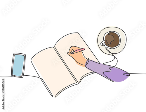 Single continuous line drawing of hand gesture writing on an open book beside a cup of coffee and smartphone. Writing draft business concept. Modern one line draw design graphic vector illustration