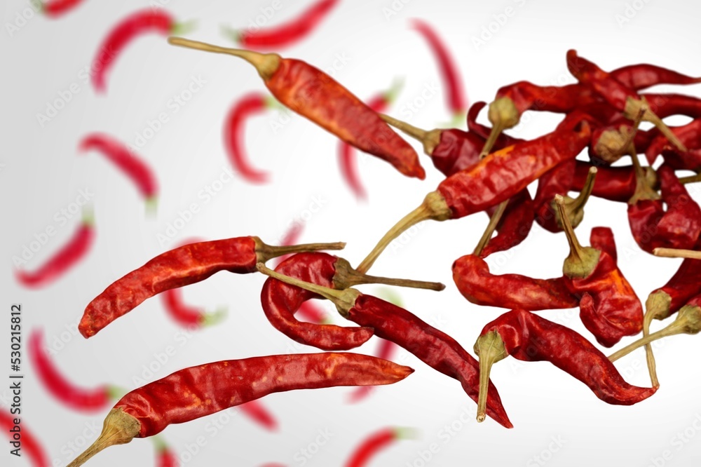 Obraz premium Falling red hot chilli peppers vegetables