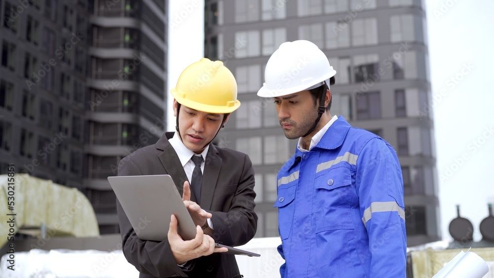 Professional Asian foreman and construction manager talking - discussing together. Professional Asian foreman and construction manager talking - discussing together.