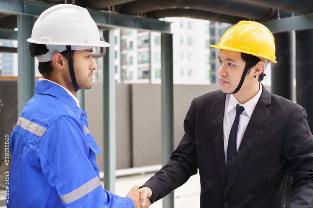 Professional Asian foreman and construction manager talking - discussing together. Professional Asian foreman and construction manager talking - discussing together.