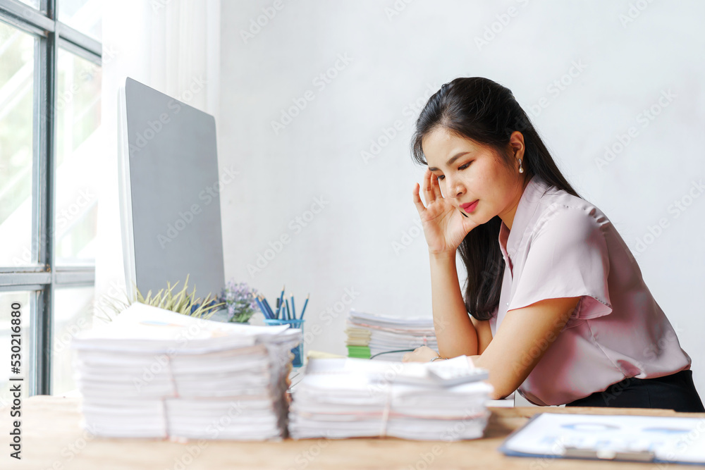 Tired and stress young Asian woman office worker feeling sick at desk in office workplace. Tired and stress young Asian woman office worker feeling sick at desk in office workplace.