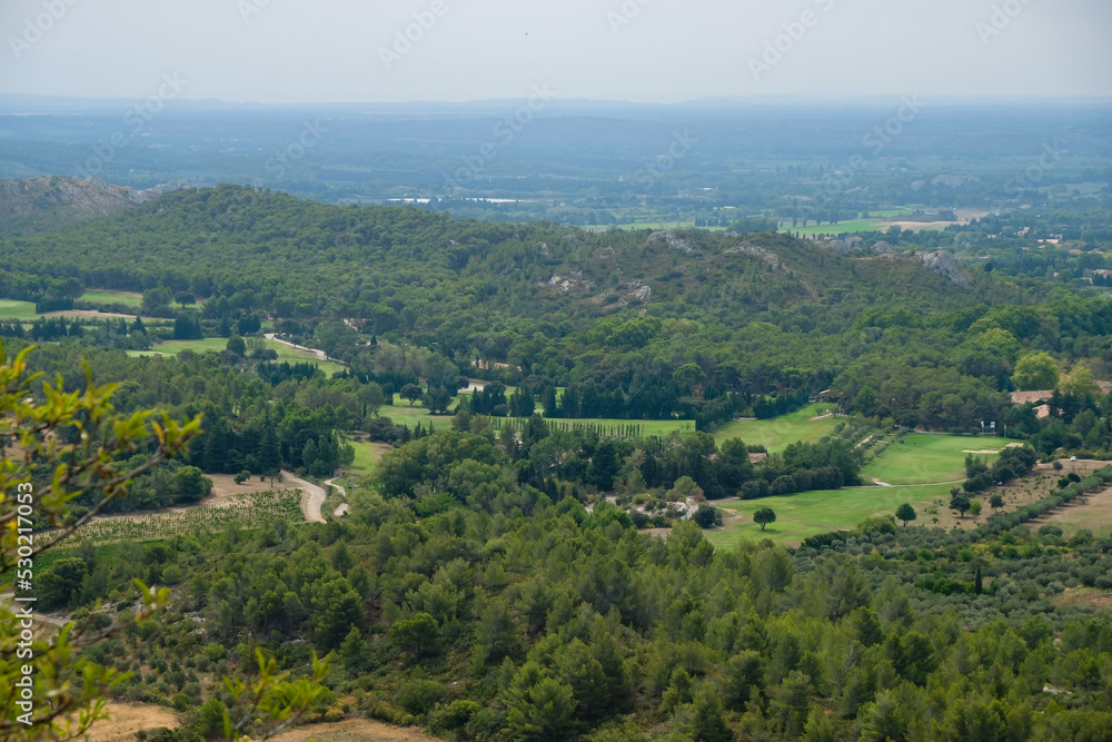 View of the golf courses from Les Baux-de-Provence, France. Dry summer season 2022. View of the golf courses from Les Baux-de-Provence, France. Dry summer season 2022.