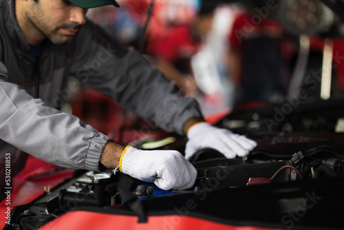 Close up hand of automobile mechanic man checking car damage broken part condition. diagnostic and repairing vehicle at garage automotive, Concepts of car care check and fixed and services insurance.
