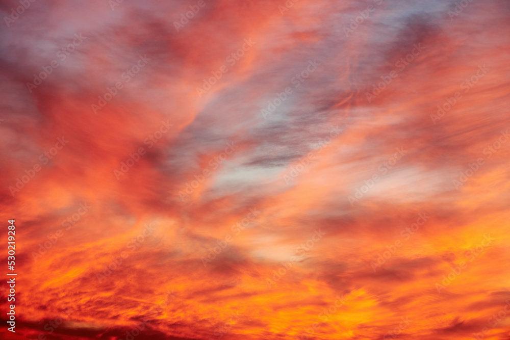 Dramatic orange sunset sky with clouds. Abstract nature backgrounds