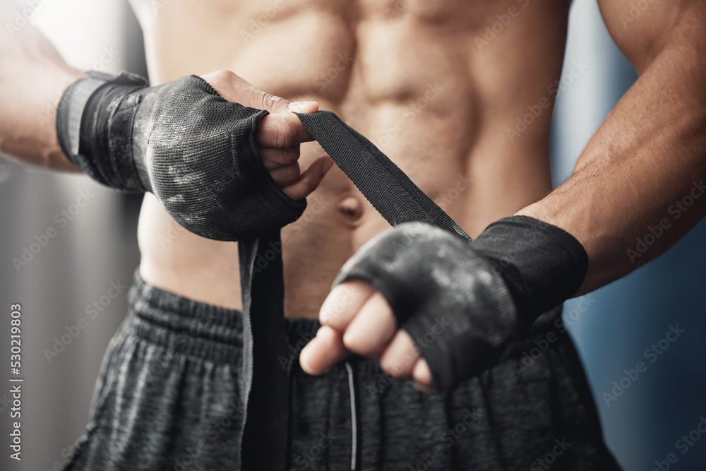 Training, fitness and boxing man prepare for workout or match at gym or fitness center with hand wrap. Closeup of athletic boxer getting ready for strength, cardio and endurance kickboxing challenge - obrazy, fototapety, plakaty 
