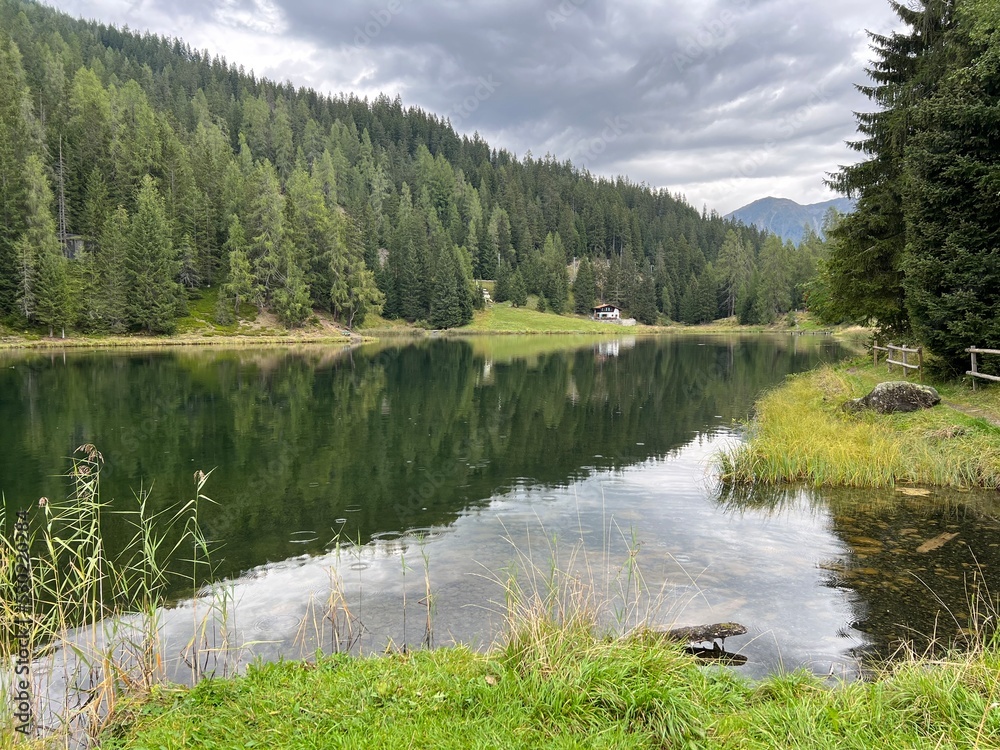 Fototapeta premium Alpine mountain lake Schwarzsee or Black Lake between the tourist towns of Davos and Klosters - Canton of Grisons, Switzerland (Kanton Graubünden, Schweiz)