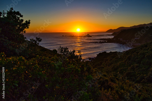 Fototapeta Naklejka Na Ścianę i Meble -  Sunset over Houghton Bay, Wellington, with views to the South Island, New Zealand