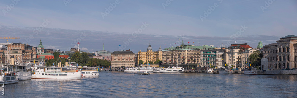 Fototapeta premium The bay Strömmen with hotels, steam boats and commuter boats at piers, a sunny autumn day in Stockholm