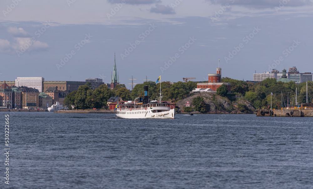 Old steam boat leaving for the archipelago, a sunny autumn day in Stockholm