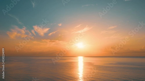 Sun rising above the sea at dawn. Colorful sunrise sky. 4K time-lapse.